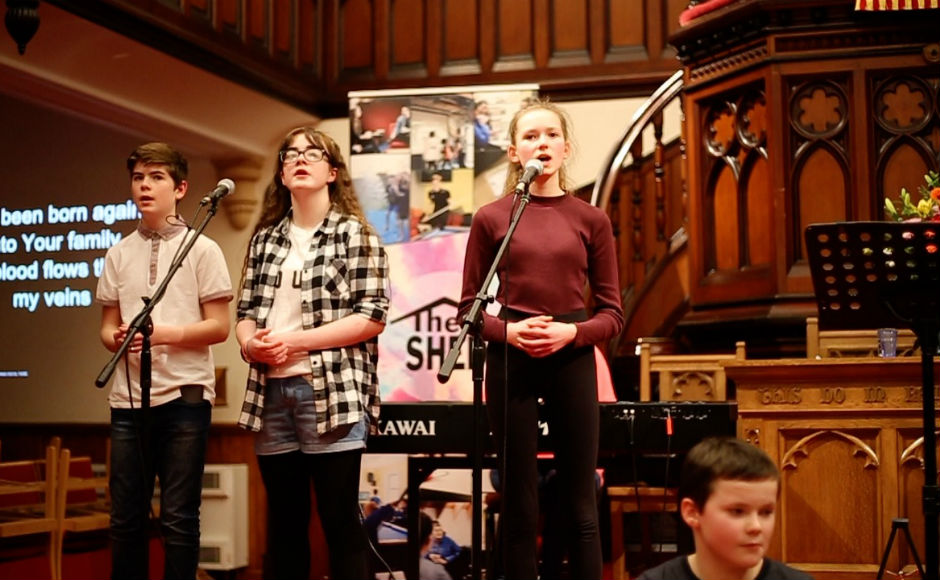 Young people on the stage at Martin's Memorial Church Stornoway