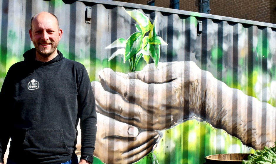 Youth team leader Neil Young next to the first piece of public art in Blackhill in 15 years painted by Rogue One. 