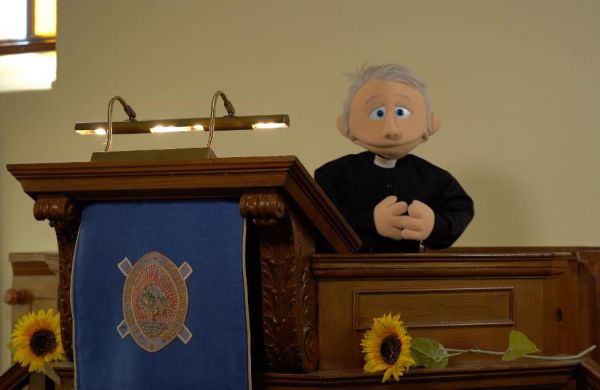 A puppet minister in the pulpit from the Intro video series