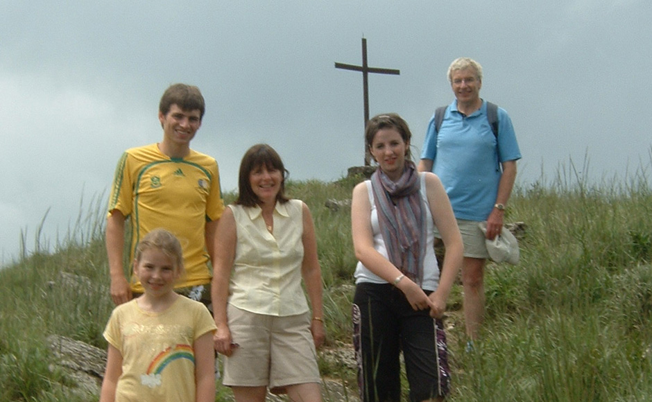 The Sinclair family on a previous visit to Ghana on a hill with a cross in the background