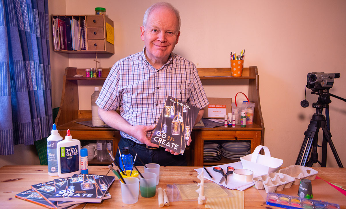 Rob Rawson holding his new book, Go Create