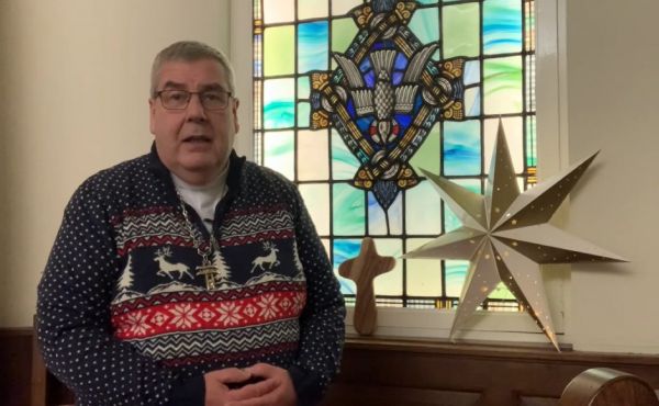 Rt Rev Dr Shaw Paterson next to a star and a cross with a dove in the background