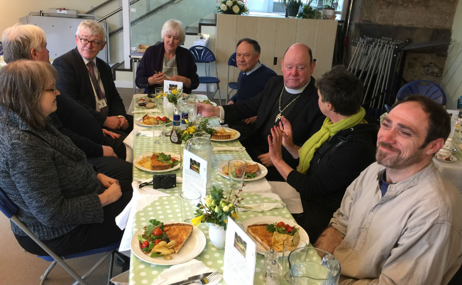 A group including the Moderator enjoying a meal
