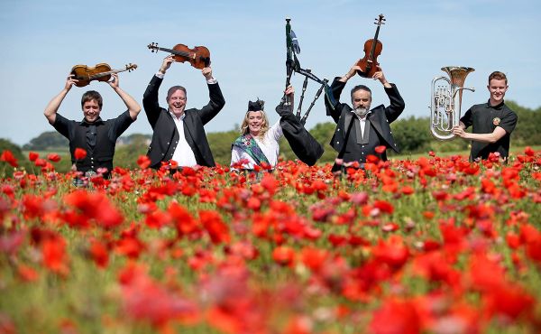 Musicians in a field of poppies