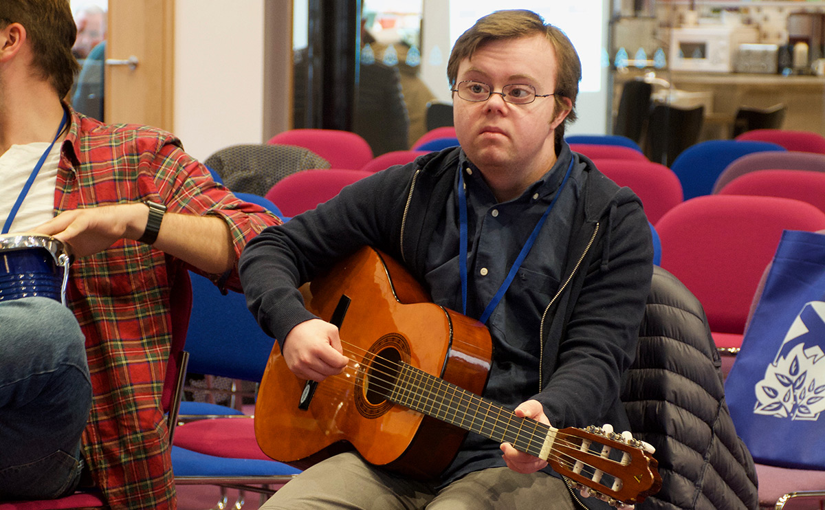 Young person playing guitar