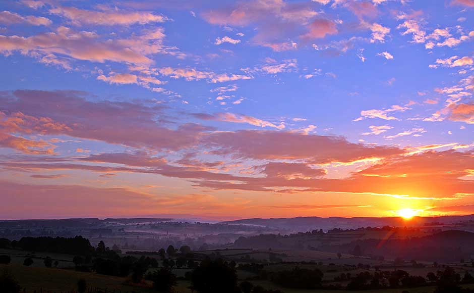 Sunrise over mistly landscape